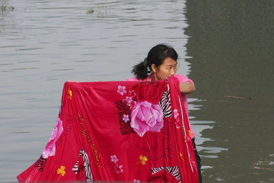 A beautiful woman washing a beautiful tablecloth (or something!)