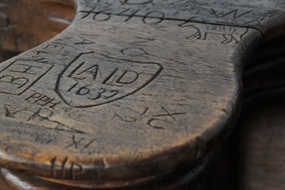 400 year old vandalism in the arm rest of the monk benches