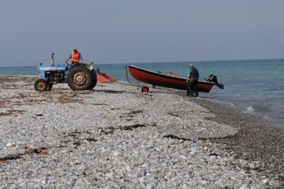 Old Ford tractor hauling in a fishing boat from the Baltic Sea