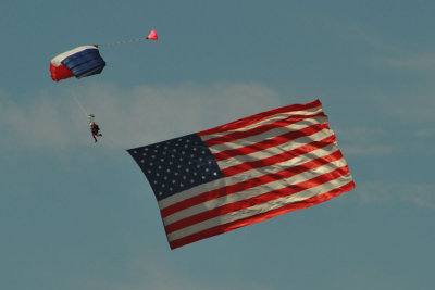 Liberty parachute team bringing in Old Glory