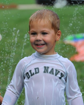 Mason under the sprinkler at his 3rd birthday party