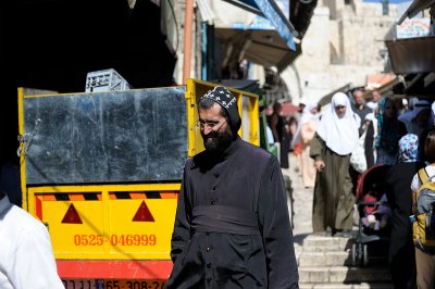 Coptic monk crossing the Muslim quarter