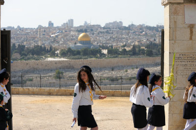 Girls at Palm Sunday procession, with Dome of the Rock in the background