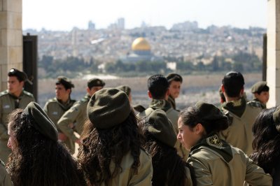 Christian teenagers in Palestinian scout uniform on backdrop of Temple Mount and Dome of the Rock