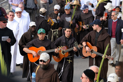 Monks playing guitar at the Palm Sunday procession