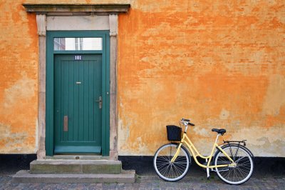 A yellow bicycle against yellow wall