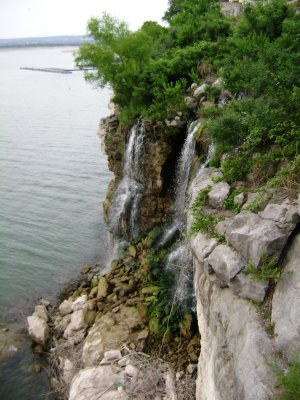 This is that waterfall I mentioned before that is located to the right of the built-out pier with park bench on it.