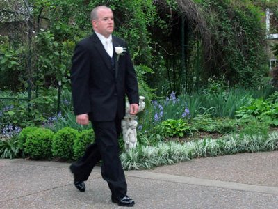 Matt walking briskly to the altar to await Crystal's arrival