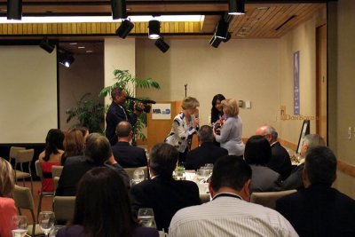 Dickie K. Davis and Marcia Fernandez-Morin presenting gifts to Sonja R. Judy