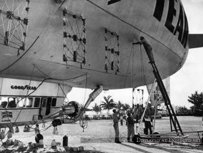 1947 - workers installing aerial signage on the side of the Goodyear Blimp Ranger NC-1A at Watson Island, Miami
