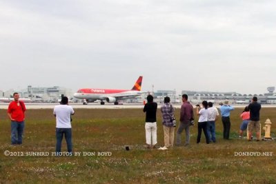 2012 MIA Airfield Tour - bus #2 tour group with Avianca A320 taking off on runway 27 in the background
