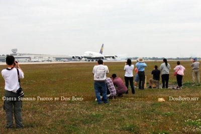 2012 MIA Airfield Tour - bus #2 tour group with the Lufthansa A380 landing on runway 27 in the background