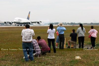 2012 MIA Airfield Tour - bus #2 tour group with the Lufthansa A380 landing on runway 27 in the background