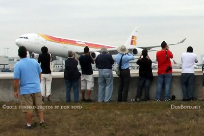 2012 MIA Airfield Tour - closeup of tour group photographing Iberia A-340 landing on runway 30