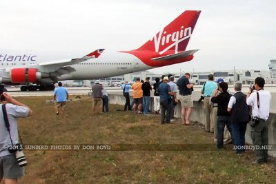 2012 MIA Airfield Tour - tour group photographing Virgin Atlantic B747-4Q8 G-VHOT landing on runway 30