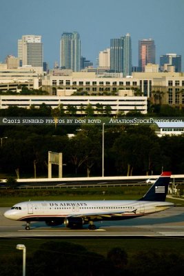 May 2012 - US Airways Airbus A320 starting takeoff roll at TPA with the downtown Tampa skyline in the background stock photo