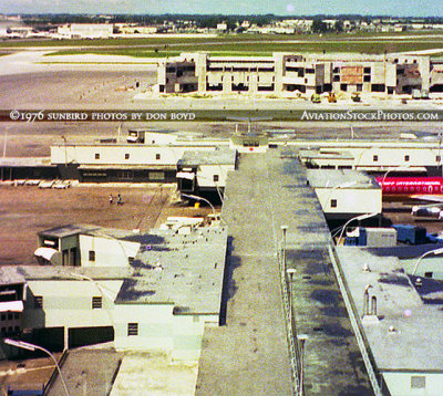 1976 - view of old Concourse E and the new E-Satellite under construction