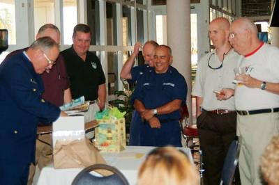 BMCM Paul DeBold opening gifts at his retirement ceremony