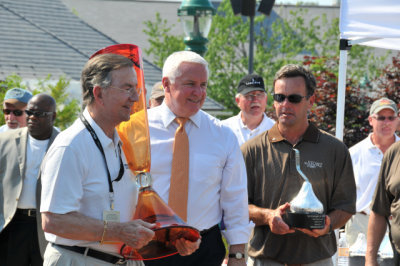 Best of Show car owner Jim Patterson, left, receives the Governor's Cup and The Elegance at Hershey Kiss Trophy. (4822)