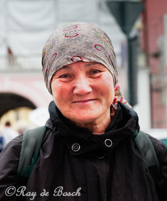 An Estonian woman outside the Nevsky church tries hard to smile for the camera...
