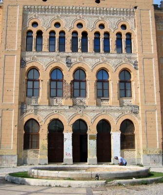 the pockmarked facade of the central grammar school in mostar
