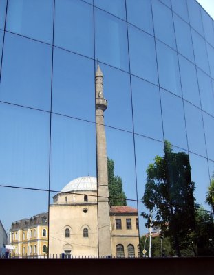 glass offices and stone mosques in prishtina