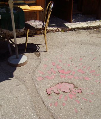 a sarajevo rose: mortar impact filled in with red paint