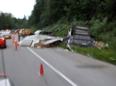 Wreckage of the tractor-trailer which seems to have flipped.