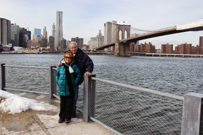 Orna and Moshe at the Fulton Ferry Landing Pier in Brooklyn with the Brooklyn Bridge, East River and Manhattan in the background