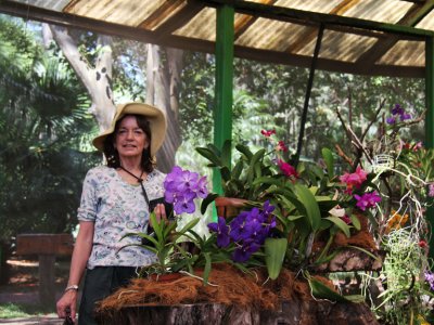 Judy with a few of the many orchids at the Botanical Orchid Garden