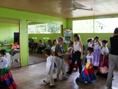 Judy dancing with students at a small, rural school.