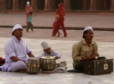 musicians in front of a mosque