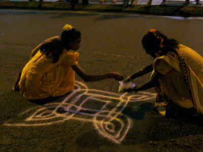 during the festival, women run barefoot through the streets of kl making these flowers