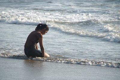 Thoughtful Girl Kneeling in the Sea Mandrem