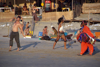 Beach Sellers and Tourists Practising Fire Sticks Arambol