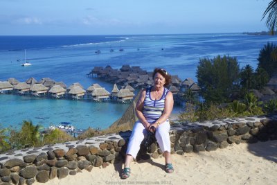 Wife possing with Sofitel Moorea in backgroud
