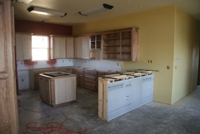 The bar and island are installed and waiting for the granite.