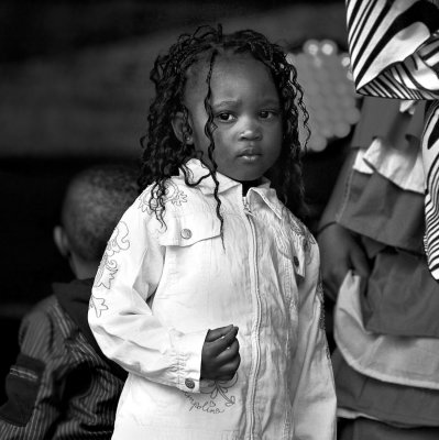 Close to her mum who`s performing a dance from Sierra Leone on stage