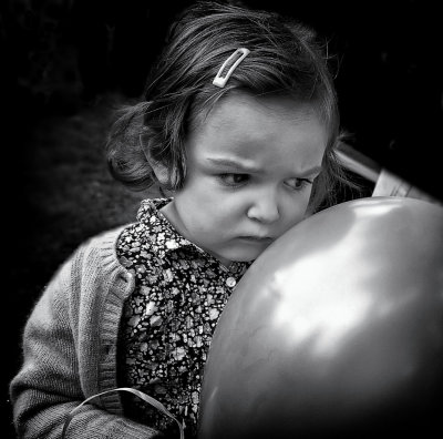 Pensive little girl with balloon