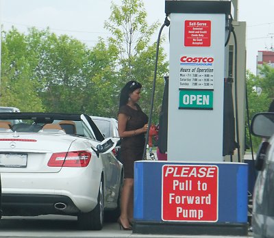 A Mercedes driver looks for inexpensive gas