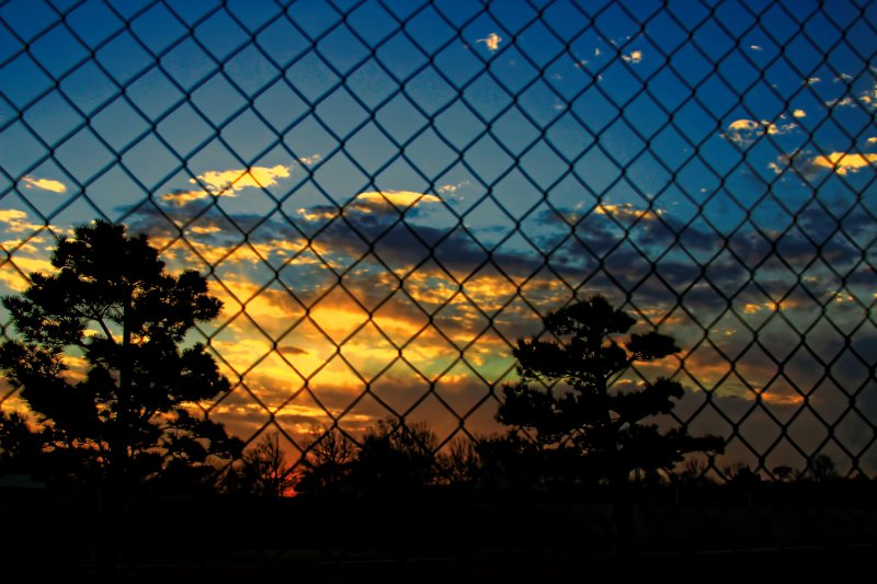 SUNRISE BEHIND THE FENCE