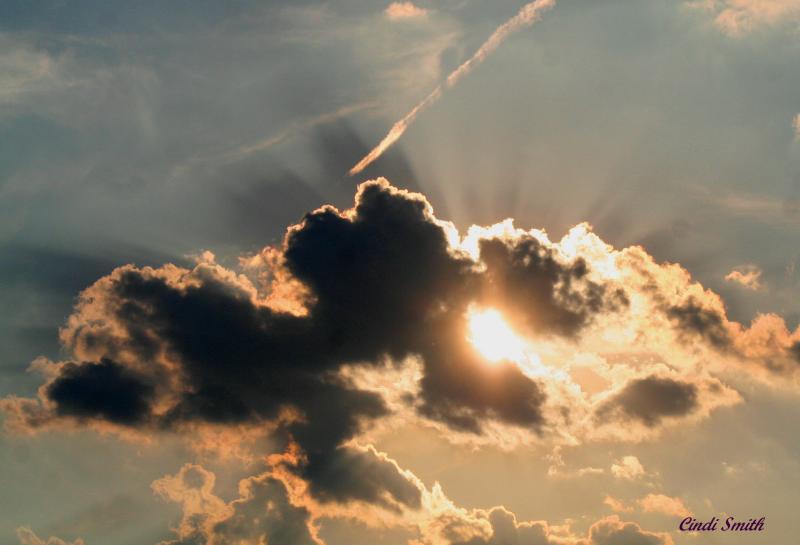 SUN BEHIND THE CLOUDS AT DUSK