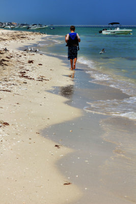 BOY WALKING ON THE BEACH