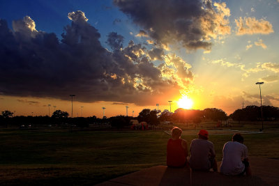 THREE ON A STEP WATCHING THE SUN SET