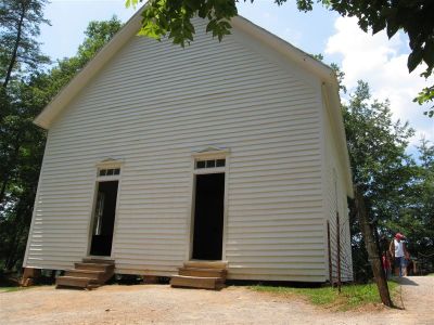 This Cades Cove congregation also began modestly meeting in a log structure with a fire pit and dirt floor. As change came rather slowly in the Smokies, it took sixty two years to get a newer more modern building. In 1902 carpenter/pastor, John D. McCampbell built the pretty white frame structure which became the Cades Cove Methodist church. The buildings two front door design was common in the 1800's in the Smokies and elsewhere.