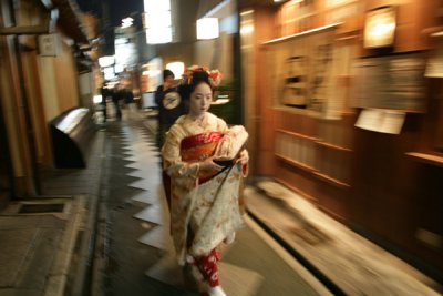 Geisha rushing to dinner in Gion