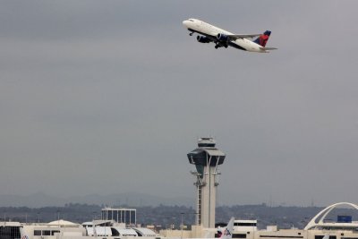 Delta Airlines Airbus A320 above LAX control tower
