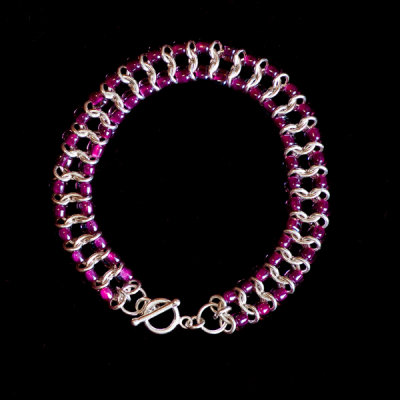 sterling calypso weave chainmaille bracelet with triangle dark maroon beads