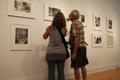 Nick Nichols and friend view Donna Ferrato's exhibit at McGuffey Art Center