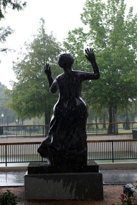 Mahalia Jackson statue in the rain from the back